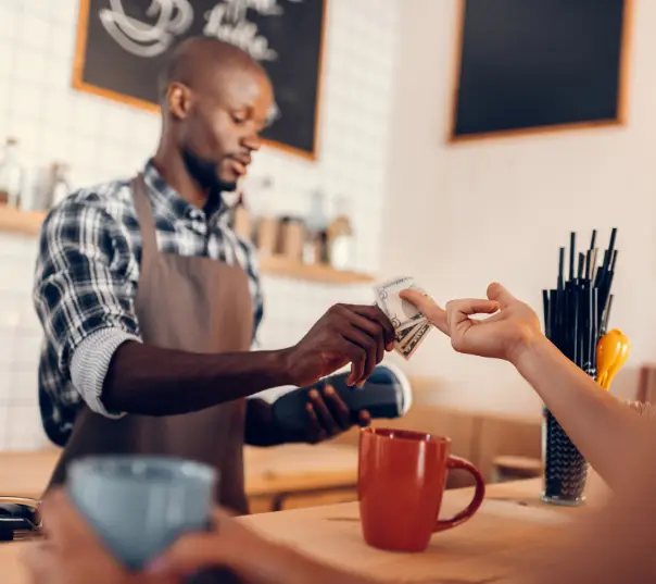 Café employee using a POS tablet to process a cash discount transaction
